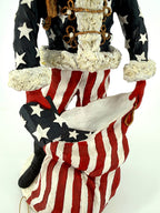 Duncan Royale Civil War Santa - detail of the gold frog closures, fur trim and the stars-and-stripes toy sack with a star-spangled gift