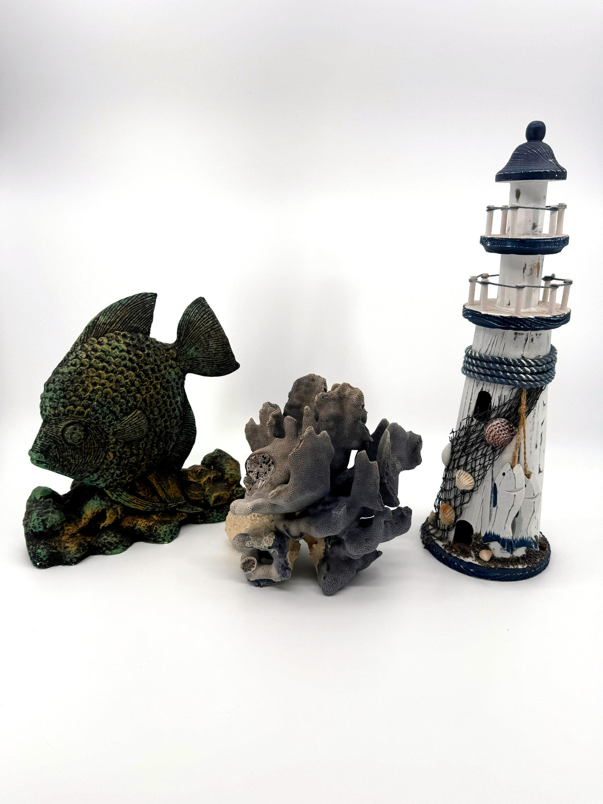 Blue coral specimen on natural base, coastal decor — styled with a fish figurine and a lighthouse for scale — props not included