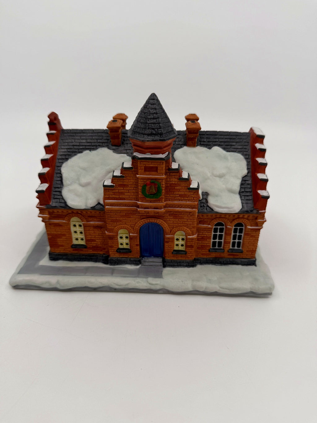 Hawthorne The Town Offices Norman Rockwell Christmas in Stockbridge 1993 — front view: red brick facade, stepped gables, turret, snow-covered roof, blue door and wreath