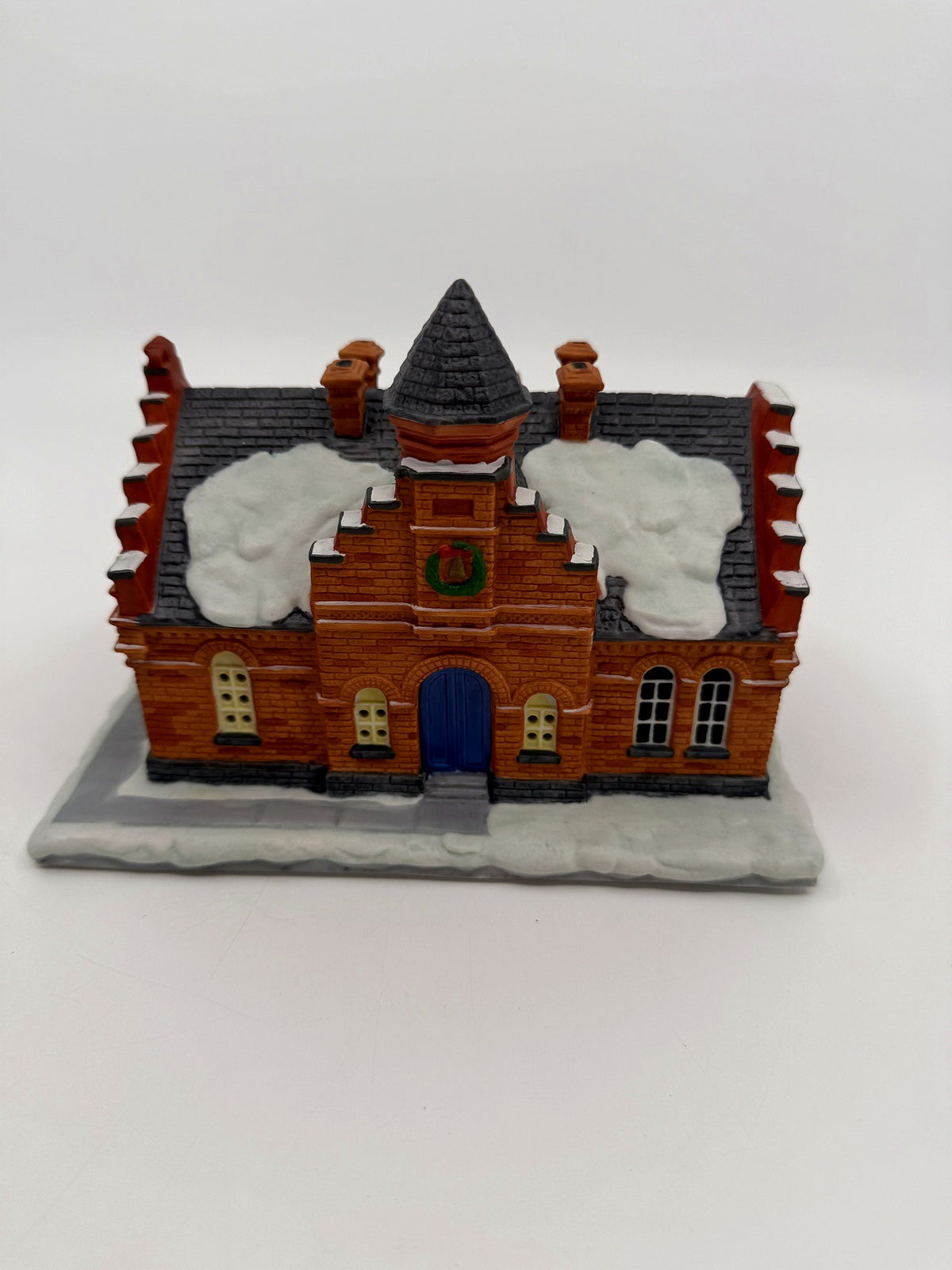 Hawthorne The Town Offices Norman Rockwell Christmas in Stockbridge 1993 — front view: red brick facade, stepped gables, turret, snow-covered roof, blue door and wreath
