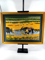 Signed Vietnamese hand-embroidered textile art — water buffalo in rice terraces — the framed piece on its stand, front view