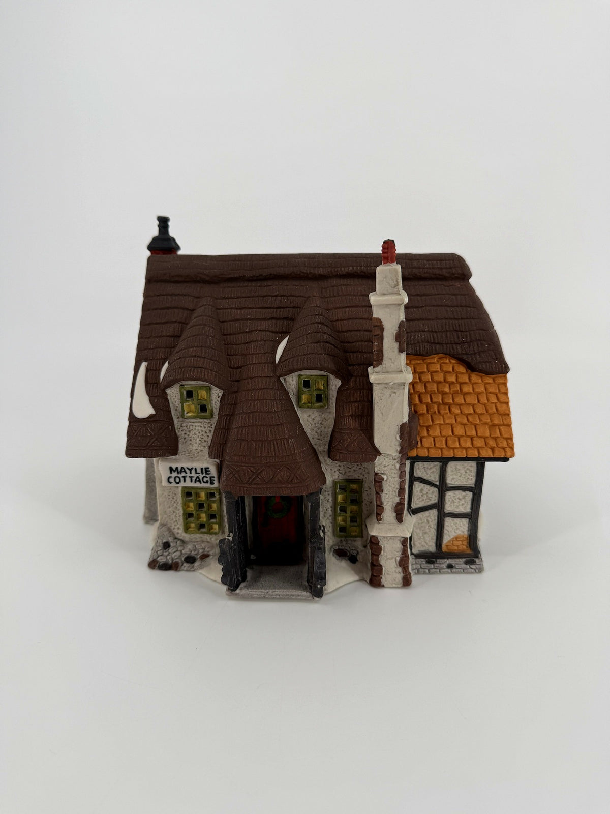 Department 56 Dickens' Village Maylie Cottage #5553-0, Oliver Twist — front view: thatched roof, covered porch, wreath on the red door