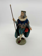 Vintage 1985 Duncan Royale Sir Christmas figurine – full front view from a distance, holding his original staff, standing on the round sage-green base