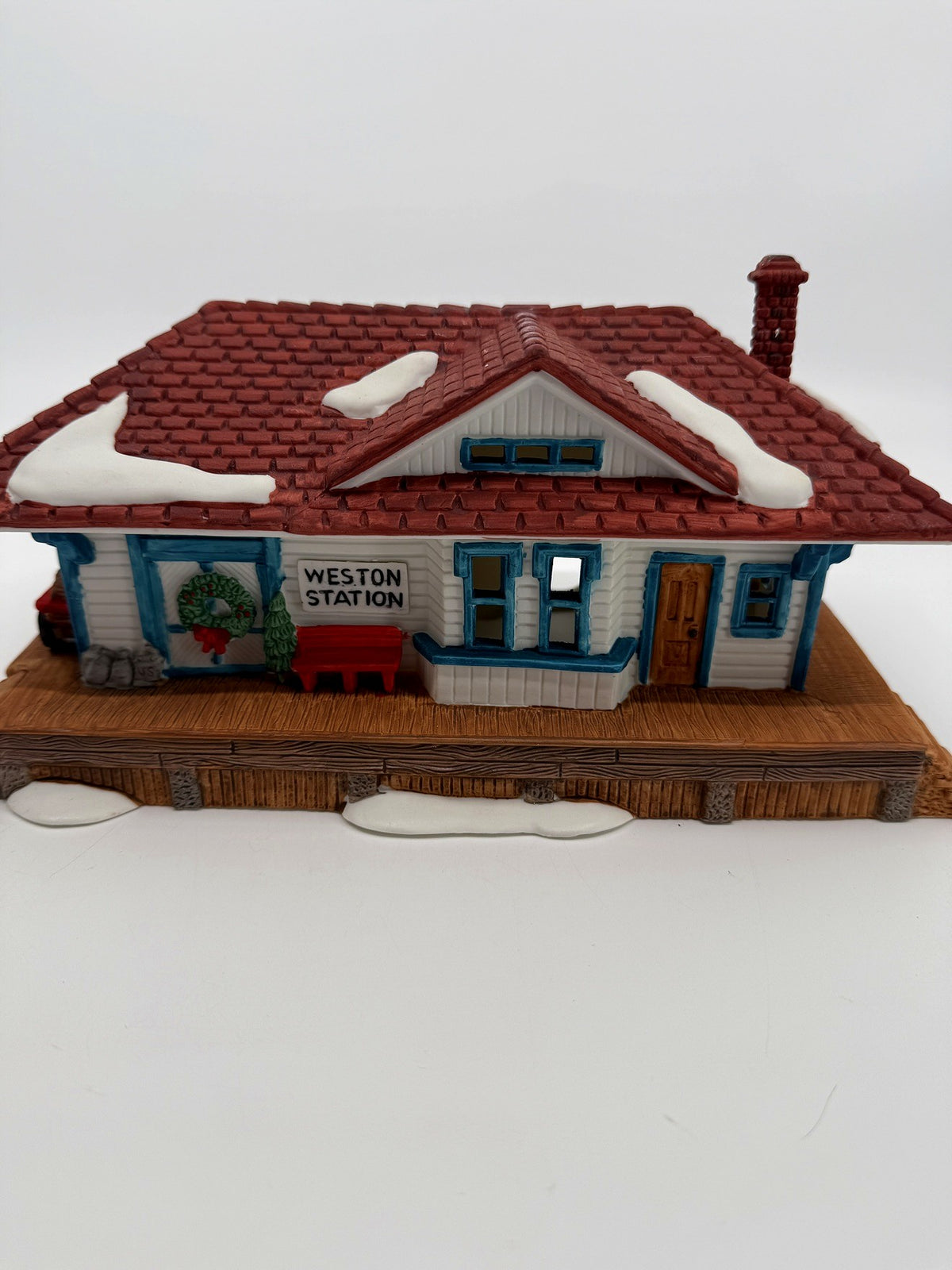 Department 56 New England Village Weston Train Station #5931-5 — front view: WESTON STATION sign, wreath, red bench, platform