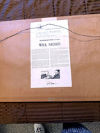 Reverse — full back of the frame with the artist's Certificate of Authenticity and biography sheet attached, hanging wire, and the Craft-Haus gallery sticker at the lower edge