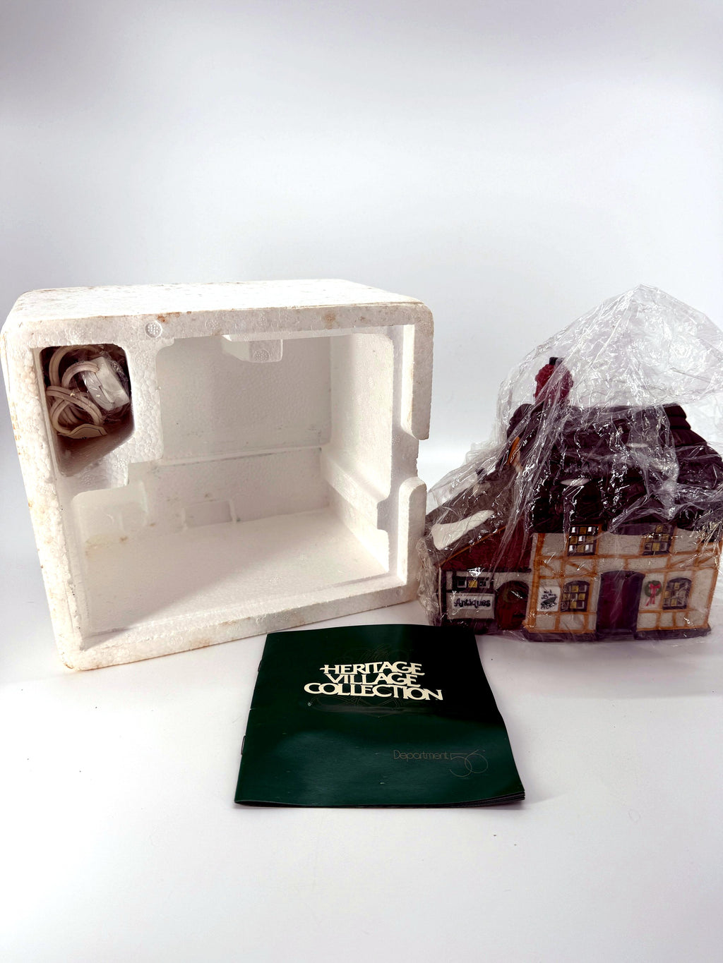 Original Styrofoam packaging, lighting cord and Heritage Village booklet