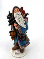 Winter Santa three-quarter front view — woven basket, lantern and brass horn at his side, long white beard