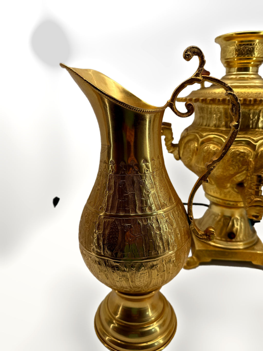 Pitcher close-up – engraved procession bands, samovar behind