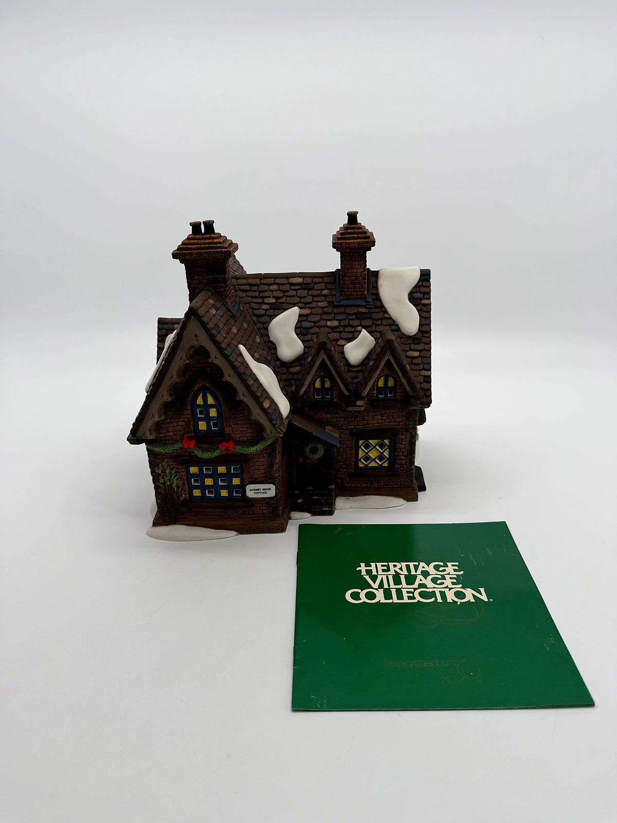 The cottage in its protective packaging with the Heritage Village Collection booklet
