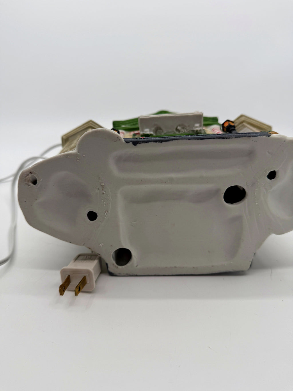 Underside of the Child's Wonder Candy Shop — plain porcelain base with the power cord and two-prong plug