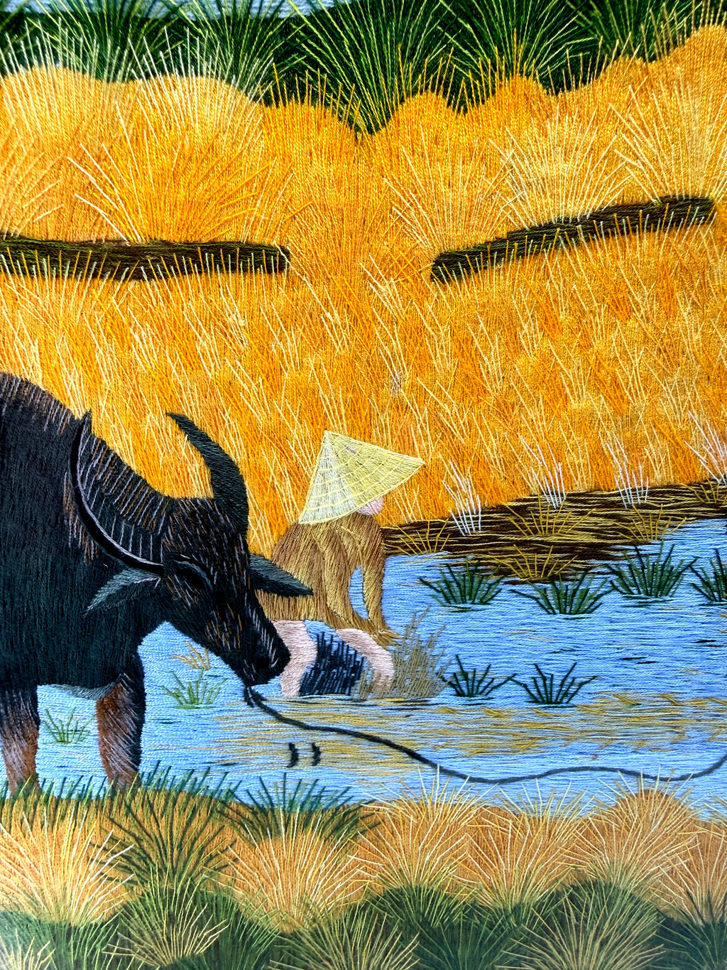 Signed Vietnamese hand-embroidered textile art — water buffalo in rice terraces — detail of the left buffalo and farmer together