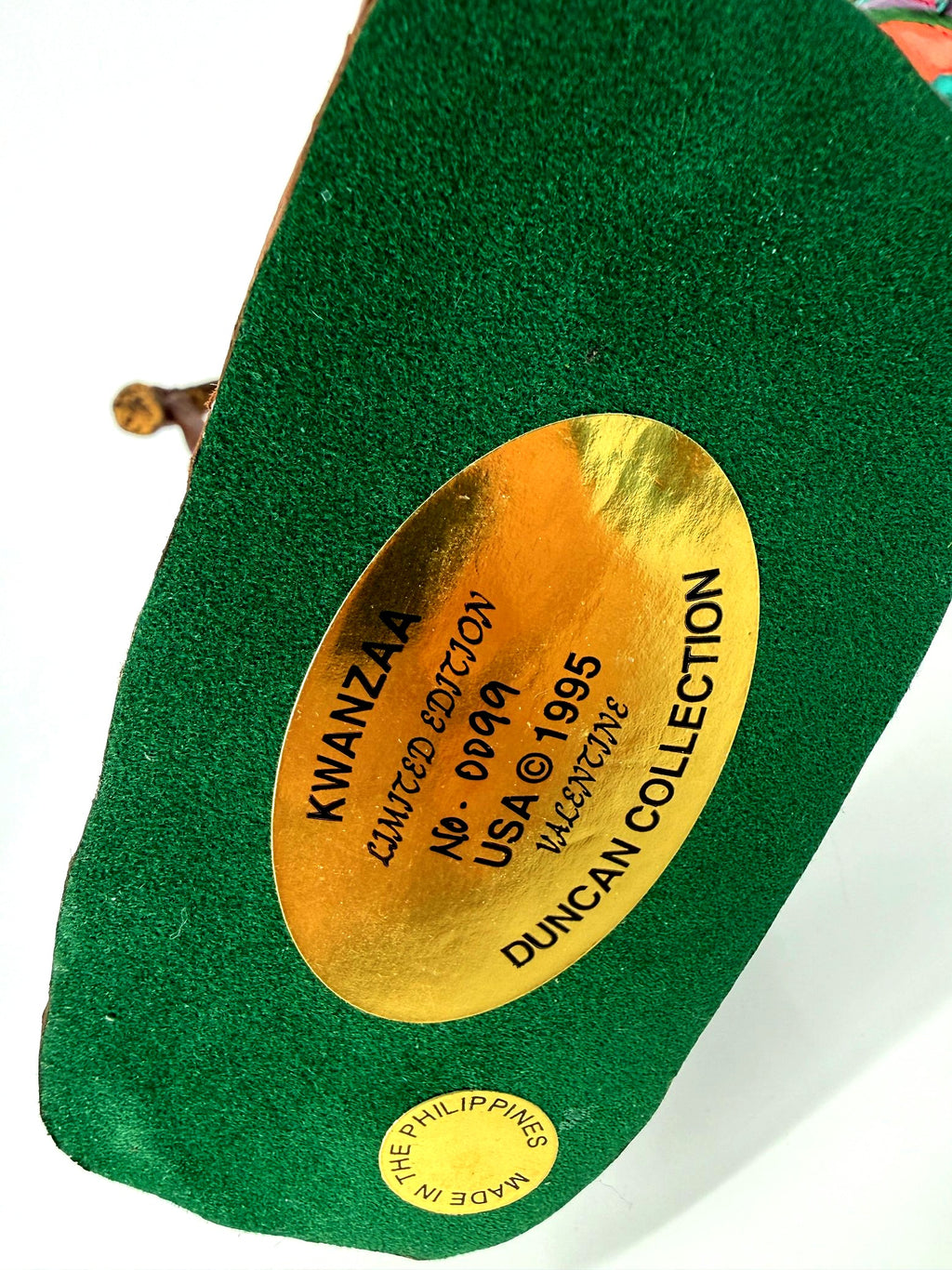 Underside of the male figure’s base — gold plaque: KWANZAA, Limited Edition No. 0999, USA © 1995, Valentine, Duncan Collection; Made in the Philippines