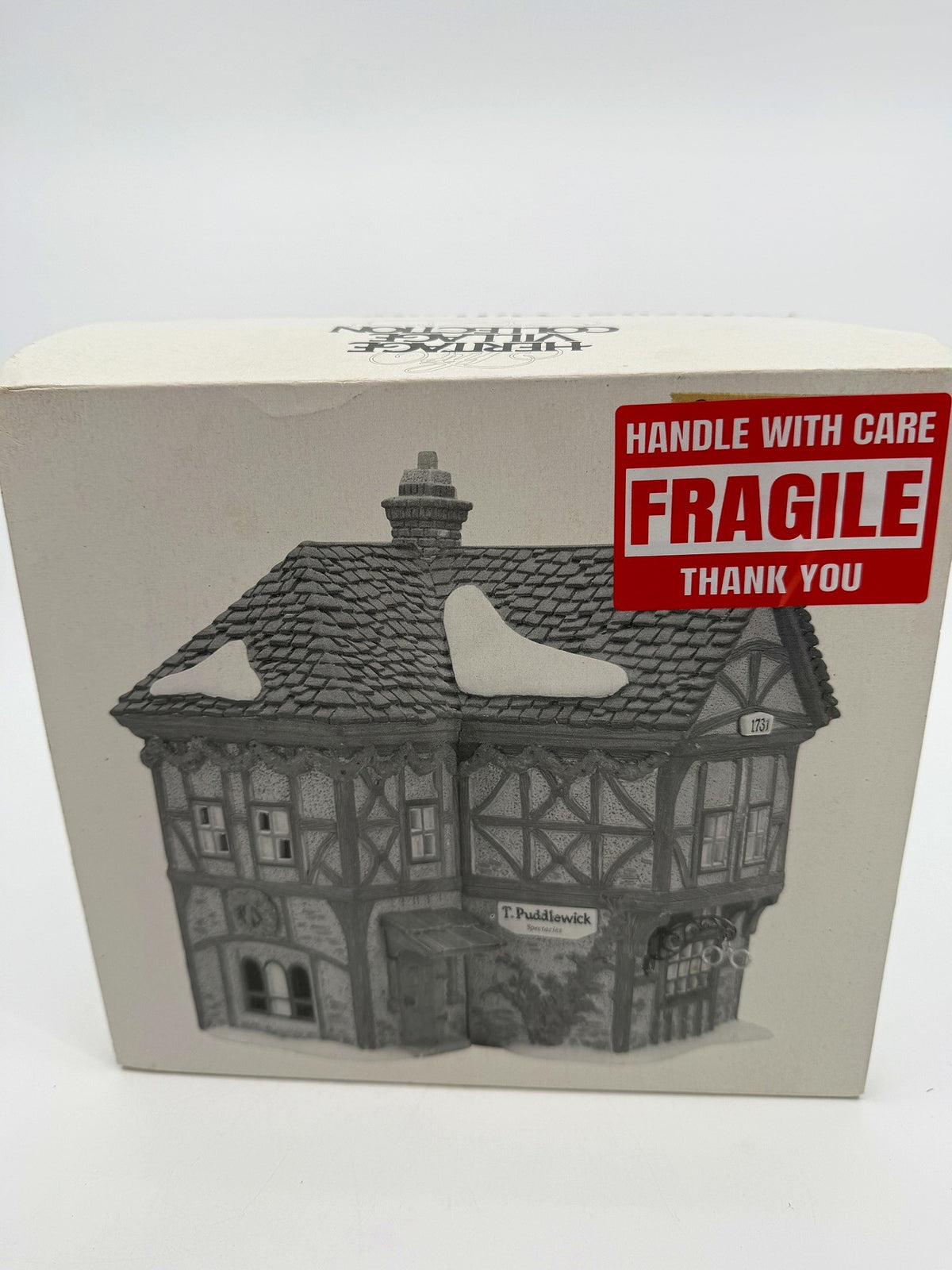 Department 56 Dickens' Village T. Puddlewick Spectacle Shop #58334 — original box front with the printed shop illustration and FRAGILE sticker