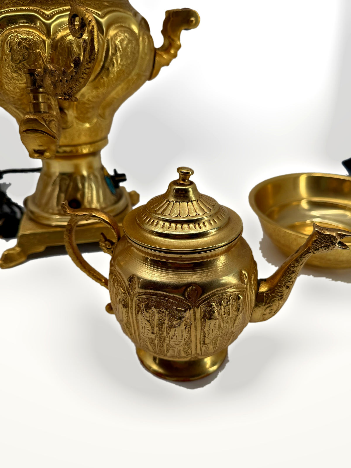 Teapot close-up – engraved figural panels and dragon-head spout