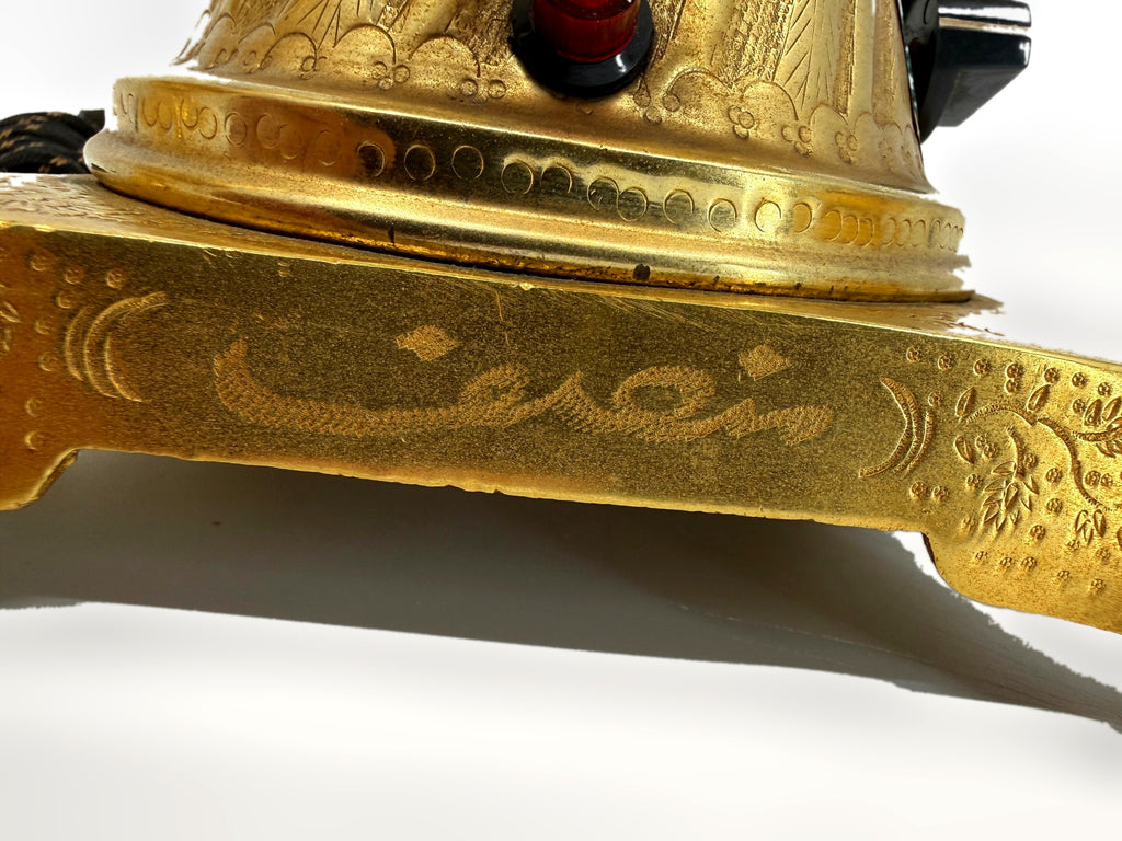 Engraved inscription on base – Persian-script calligraphy detail with red pilot light