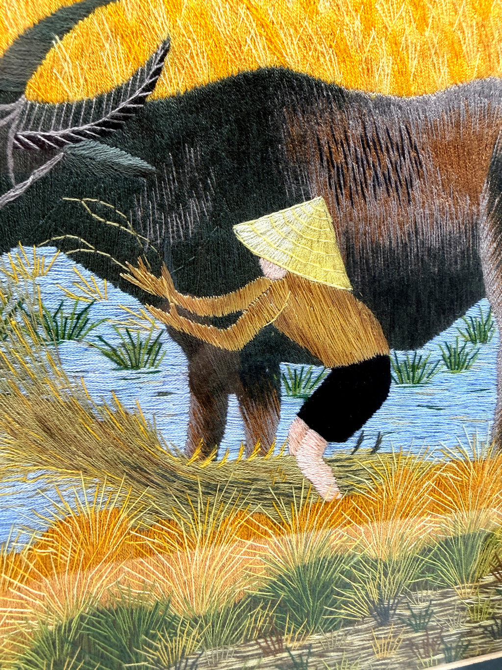 Signed Vietnamese hand-embroidered textile art — water buffalo in rice terraces — close-up of a buffalo's body and the farmer's conical hat stitching