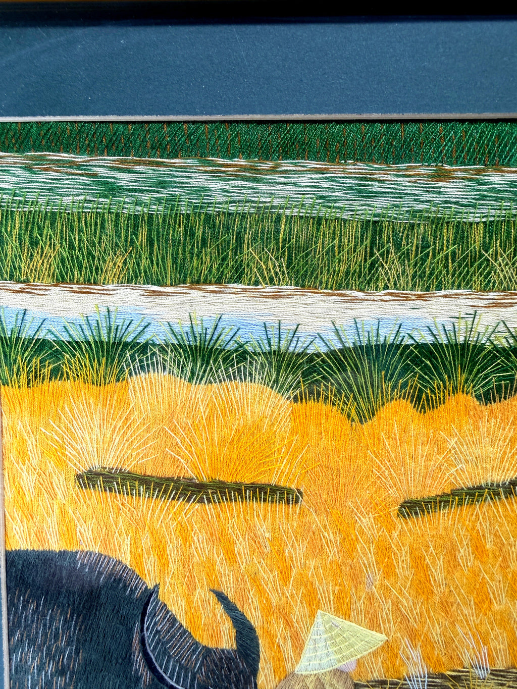 Signed Vietnamese hand-embroidered textile art — water buffalo in rice terraces — detail of the top left — stitched terraced field bands