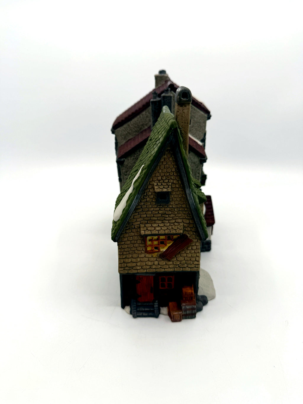 Left gable end with boarded window, crates and barrels
