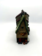 Left gable end with boarded window, crates and barrels
