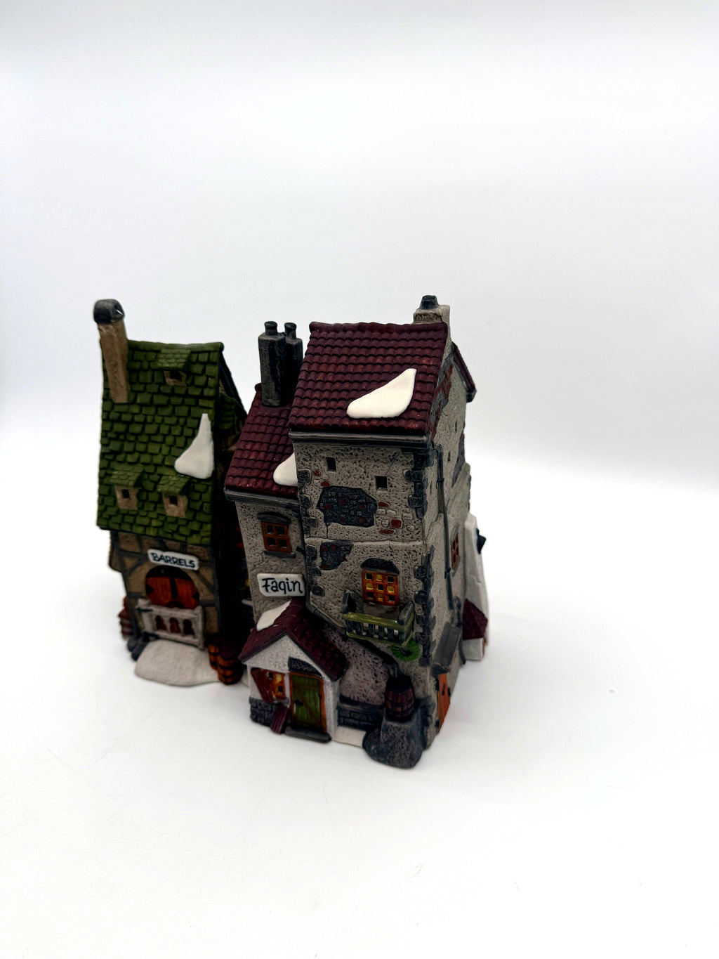 Front three-quarter view from the right, showing the stone tower, balcony and green door