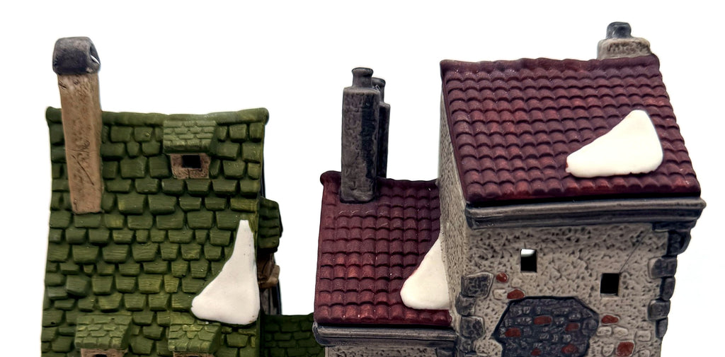 Detail of the rooflines: green shingles, burgundy tiles, sculpted snow and chimneys