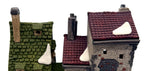 Detail of the rooflines: green shingles, burgundy tiles, sculpted snow and chimneys