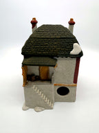 Department 56 M. Fezziwig Warehouse, Dickens' Village, 1986 – back view: raised loading dock with barrels, side stair and light cord opening