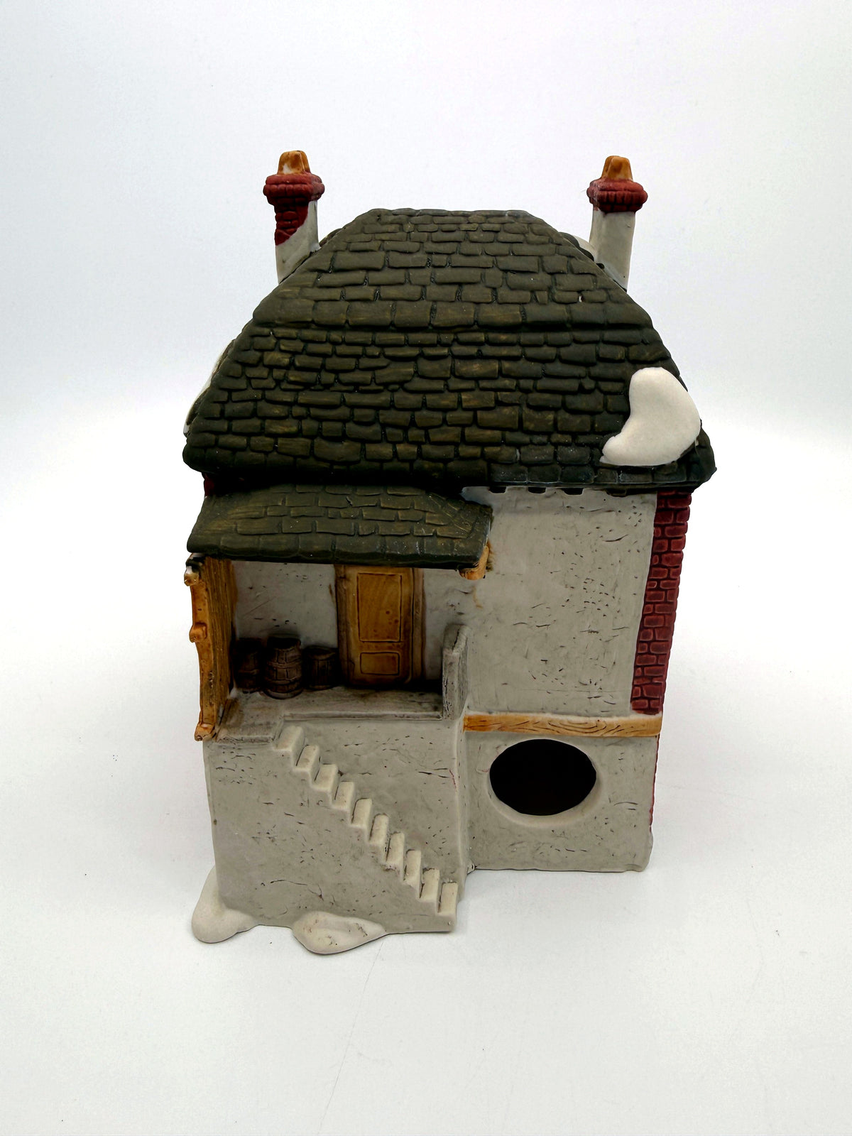 Department 56 M. Fezziwig Warehouse, Dickens' Village, 1986 – back view: raised loading dock with barrels, side stair and light cord opening