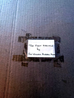 Close-up of the handwritten label on the reverse: “The First Arrivals by Sir William Russell Flint”