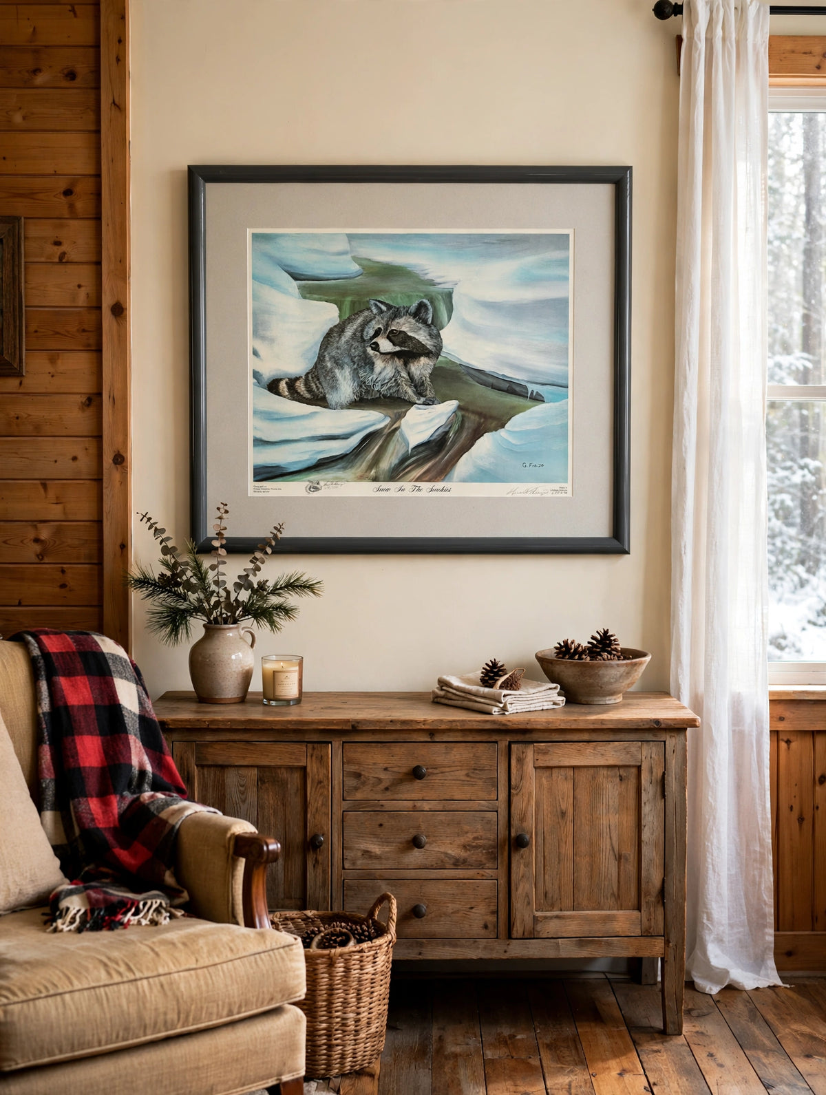 Styled lifestyle photo — the framed Snow In The Smokies print above a rustic wooden sideboard in a cozy cabin-style living room (display inspiration)