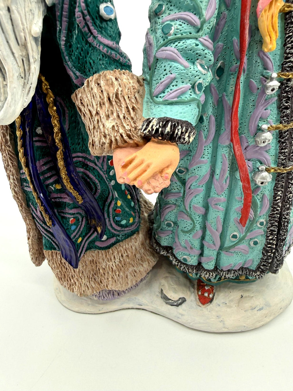 Detail: joined hands, silver bells and coat hems (enhanced)