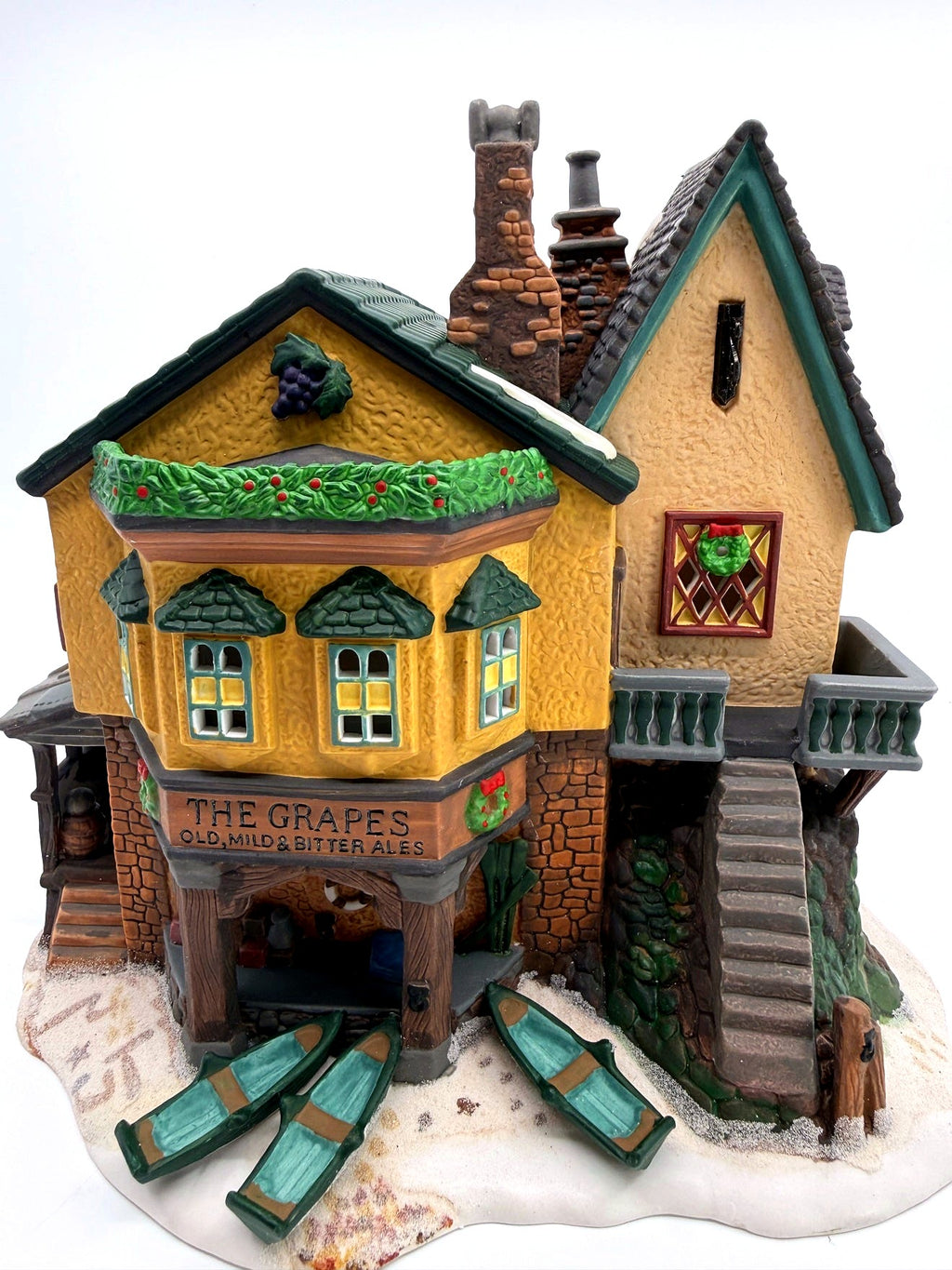 Department 56 Dickens' Village "The Grapes Inn" lighted porcelain building – front view showing the inn sign and three rowboats