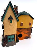 Department 56 Dickens' Village "The Grapes Inn" lighted porcelain building – back view showing the light opening and green double doors
