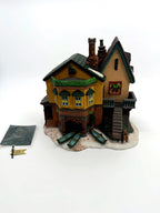 Department 56 Dickens' Village "The Grapes Inn" lighted porcelain building – front view with the hanging flag and paperwork beside the building