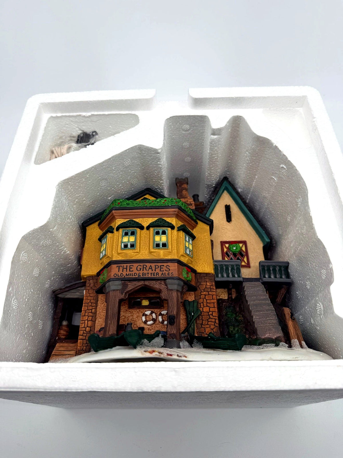 Department 56 Dickens' Village "The Grapes Inn" lighted porcelain building – seated in its original molded Styrofoam insert, light cord in its compartment