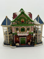 Lemax Carole Towne Child's Wonder Candy Shop lighted Christmas village building, front view — candy-cane columns, CANDY SHOP sign, and two glass bay towers with interior scenes