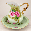 Vintage Lefton China pitcher and basin set with vibrant pink roses and gold trim on a clean editorial background