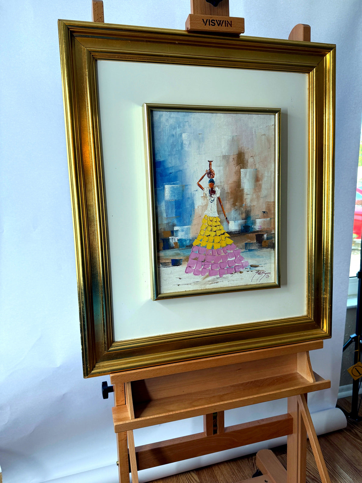 1985 signed impasto figural paintings on canvas — framed pair — the water-carrier painting from an angle on the easel