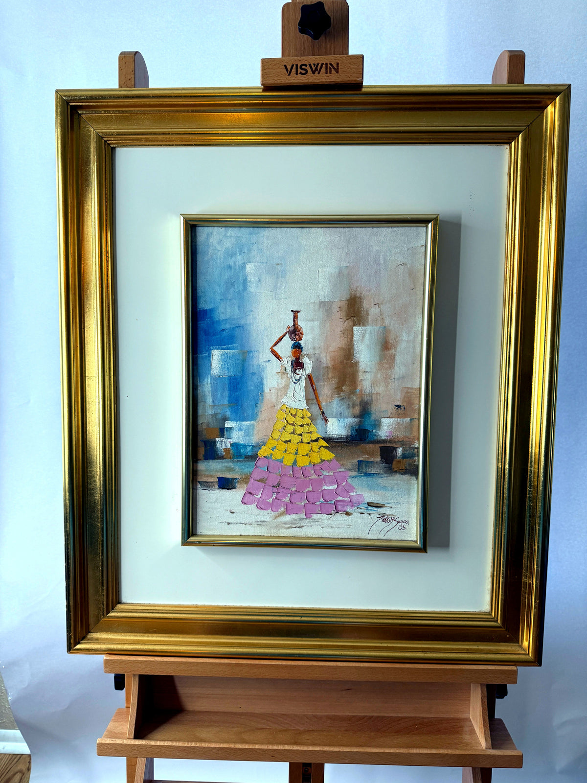 1985 signed impasto figural paintings on canvas — framed pair — the water-carrier painting on an easel, front view