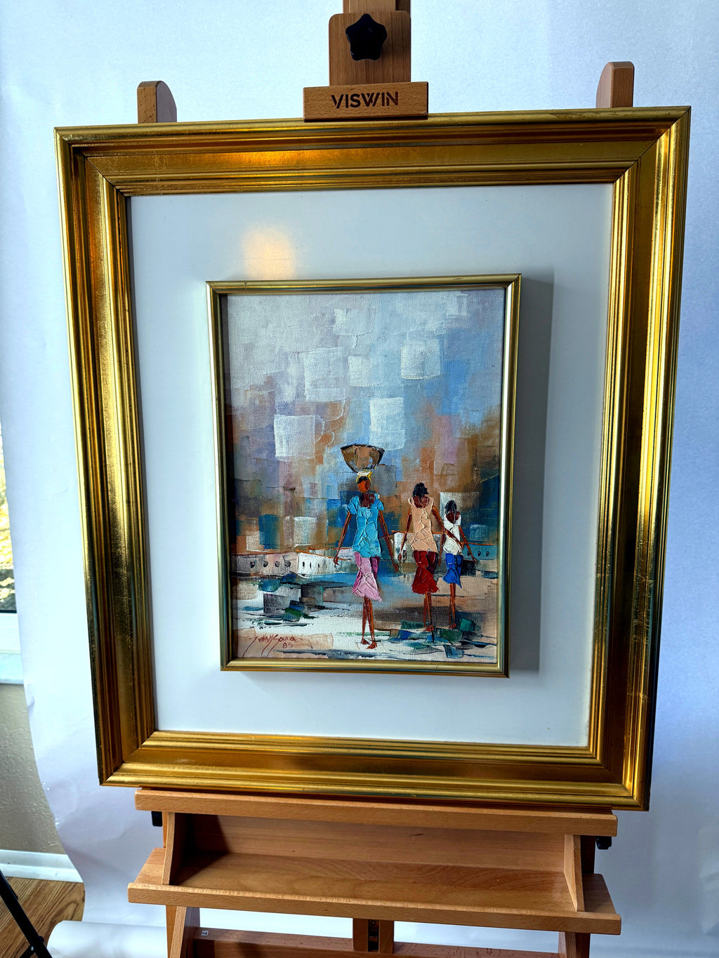 1985 signed impasto figural paintings on canvas — framed pair — the water-carrier painting on an easel, front view