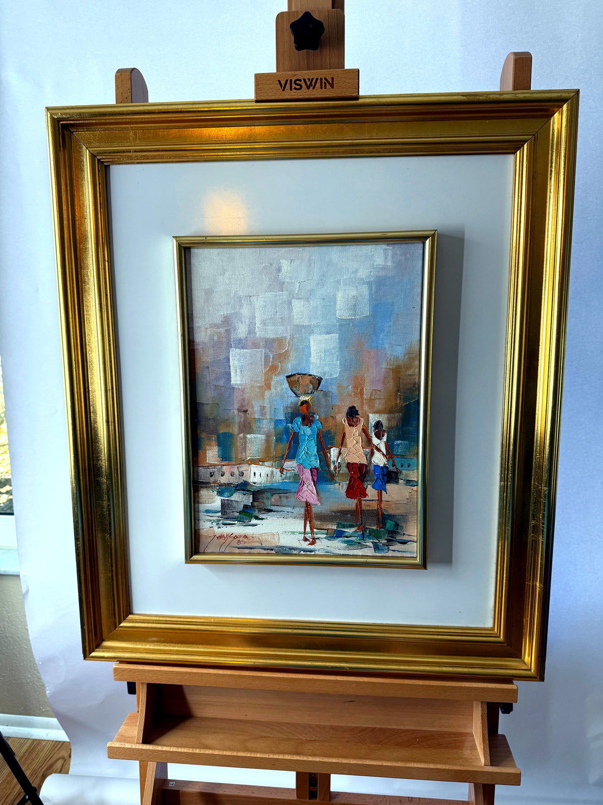 1985 signed impasto figural paintings on canvas — framed pair — the water-carrier painting on an easel, front view