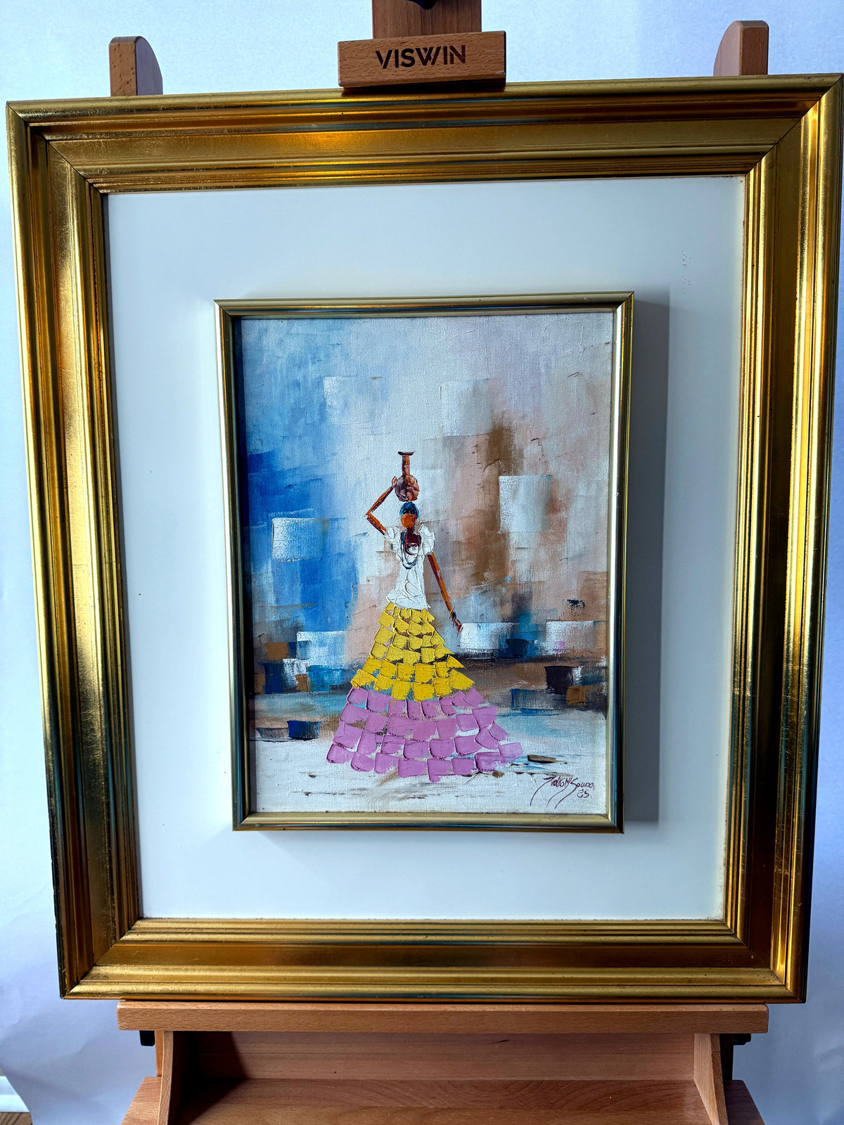 1985 signed impasto figural paintings on canvas — framed pair — the water-carrier painting on an easel, final front view