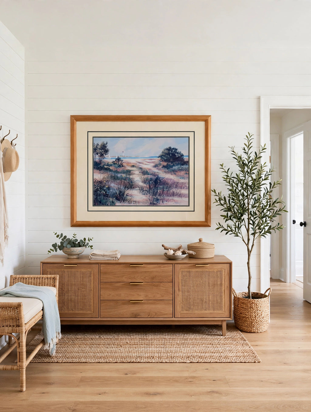 Styled lifestyle photo — the 43-inch framed print above a wood credenza in a coastal entryway (display inspiration)