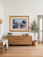 Styled lifestyle photo — the 43-inch framed print above a wood credenza in a coastal entryway (display inspiration)
