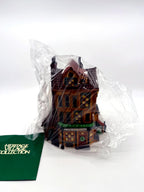 Department 56 Dickens' Village J. Lytes Coal Merchant in its protective plastic sleeve beside the Heritage Village Collection booklet, as received