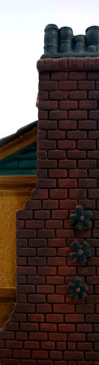 Close-up of the brick chimney with star-shaped tie plates