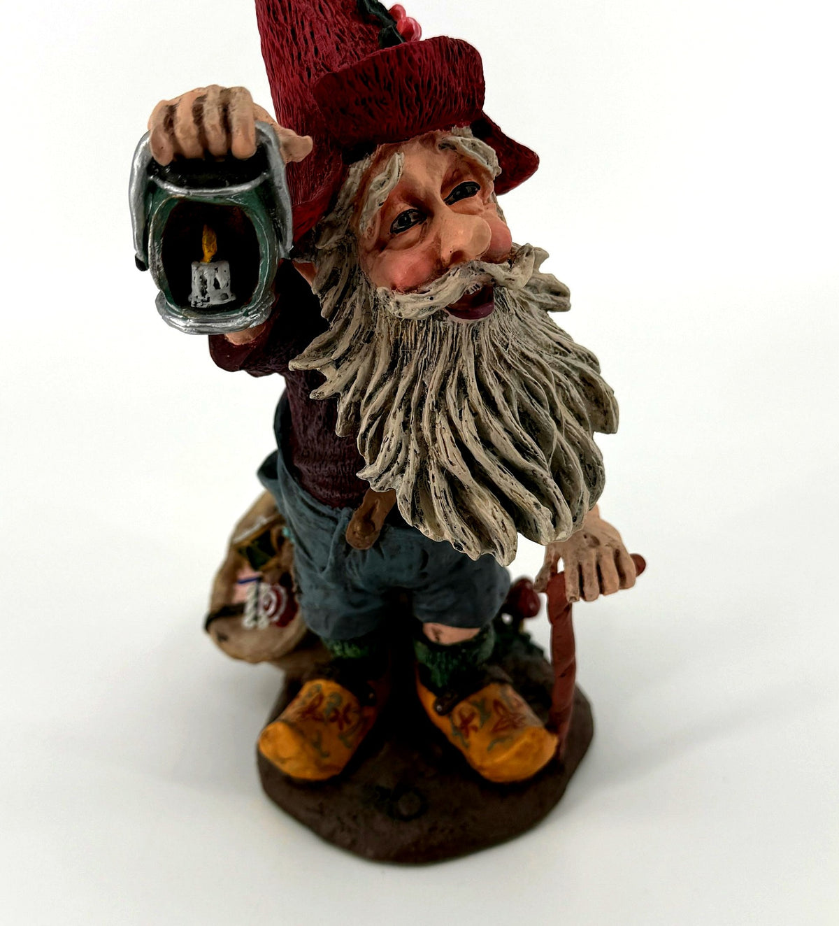 Close-up of Julenisse face, white beard, and holly-trimmed hat