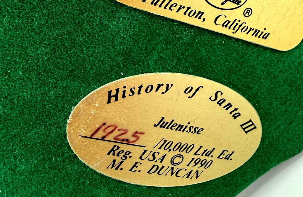Close-up of underside plaque: History of Santa III Julenisse No. 1925 of 10,000, copyright 1990 M. E. Duncan