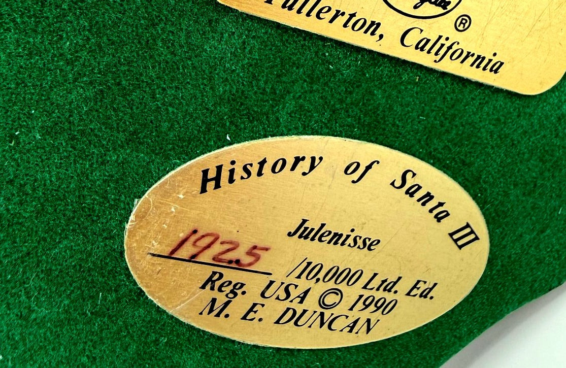 Close-up of underside plaque: History of Santa III Julenisse No. 1925 of 10,000, copyright 1990 M. E. Duncan