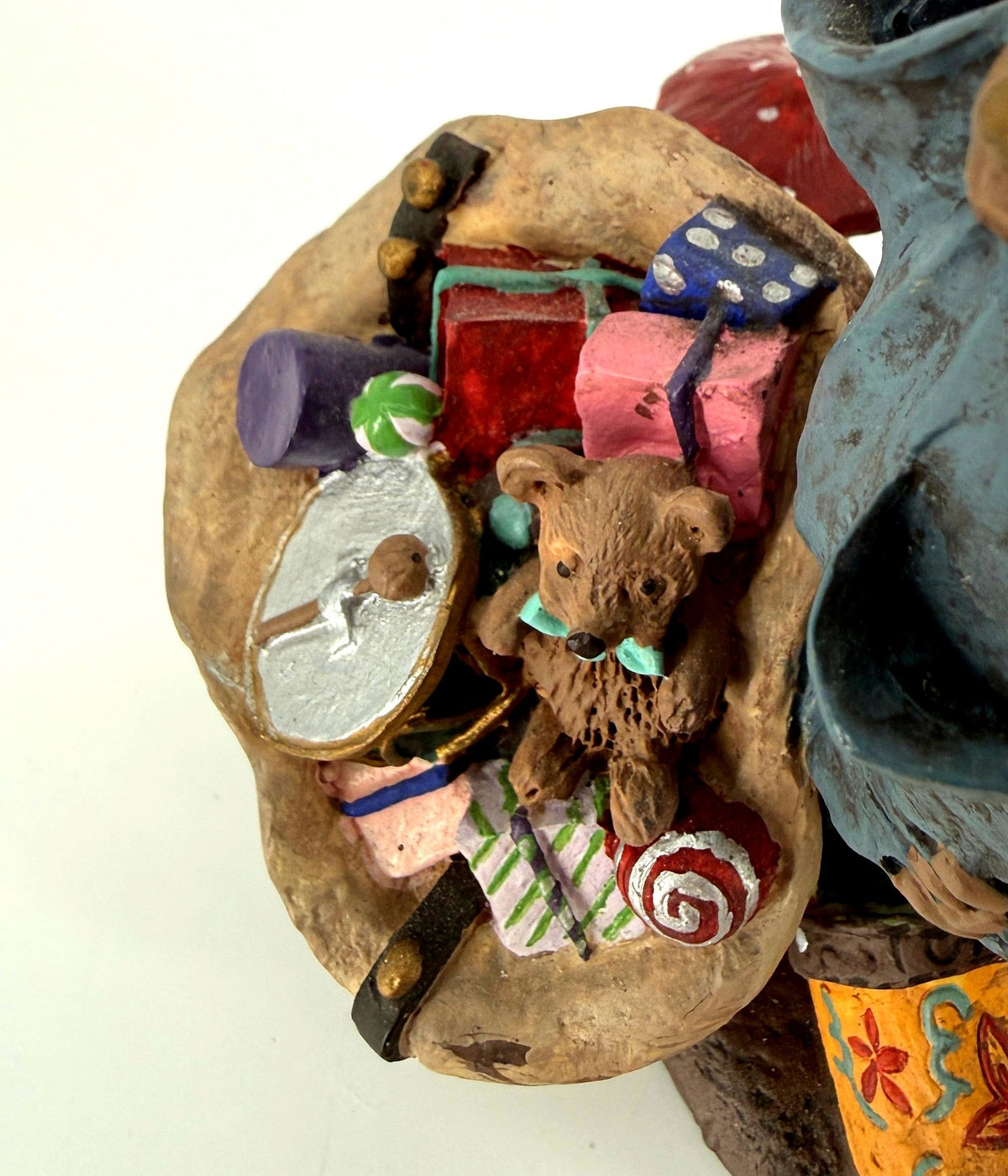 Close-up of Julenisse gift sack with teddy bear, drum, and wrapped presents